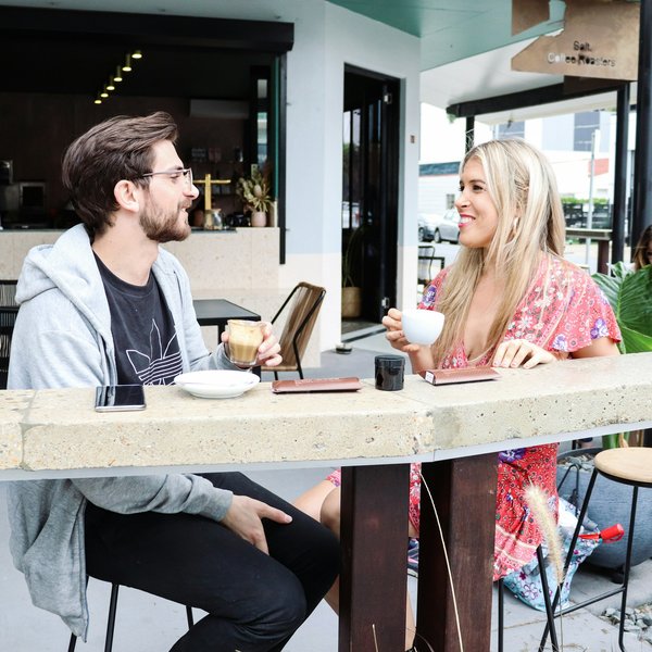 How can a cafe creatively use its small outdoor area to attract more customers?